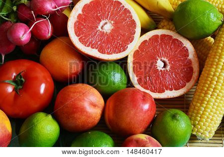 colorful vegetables and fruits with sliced grapefruit