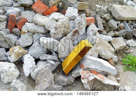 heap of rubble trash and gold bar