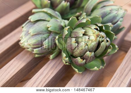 Ripe Organic Artichokes On The Wooden Lattice
