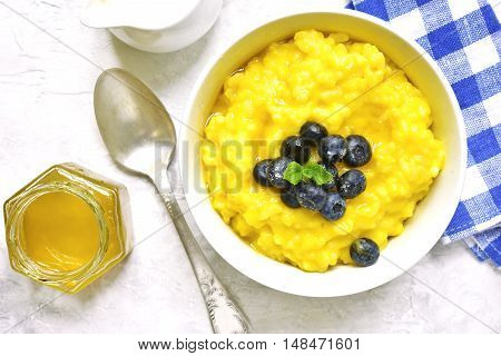 Rice Porridge With Pumpkin And Fresh Blueberry.top View.