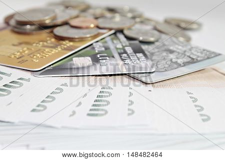 Concept of spending : Close up of credit cards and coins on Thai Baht money