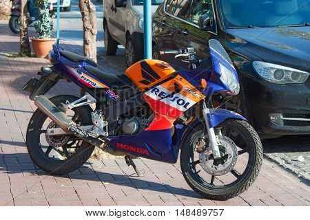TURKEY ALANYA - NOVEMBER 10 2013: Sportbike Honda in official factory team Repsol Honda colors parked on the street in the center of Alanya. Turkey.