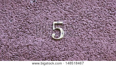 Number Five On The Wall Of A House