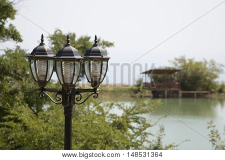 Street lamp over the pond and gazebo