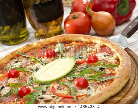 Whole Italian Pizza On Table With Ingredients