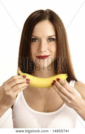 Banana Showing in Manicured Hands of Beautiful Brunette Woman
