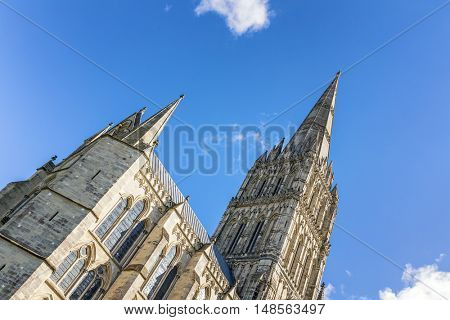 The spire of Salisbury Cathedral against blue sky. Built in the 13th century, with the spire completed in the 14th century, this is the tallest church spire in the UK. 