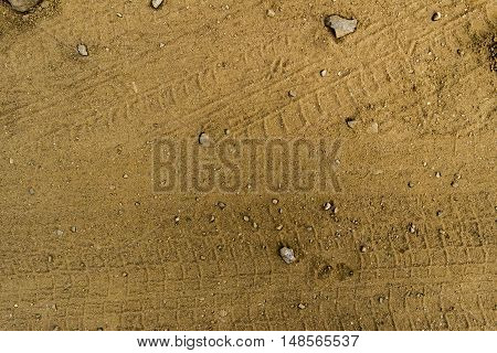 Texture of the soil, soil texture, nature background, ground, wheel tracks, traces on the ground