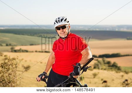Portrait Of Young Cyclist In Helmet And Glasses