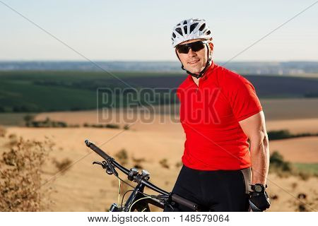 Portrait Of Young Cyclist In Helmet And Glasses