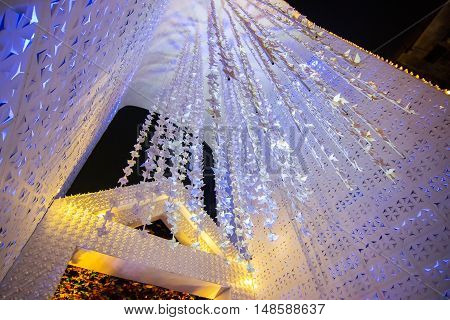 KOLKATA INDIA - OCTOBER 18 2015 : Night image of decorated Durga Puja pandal shot at colored light at Kolkata West Bengal India. Durga Puja is biggest religious festival of Hinduism.