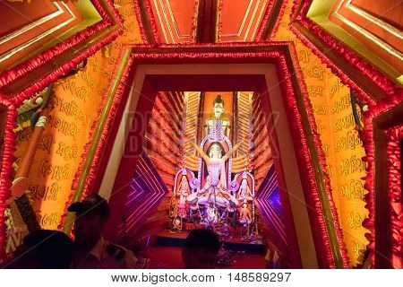 KOLKATA INDIA - OCTOBER 18 2015 : Night image of decorated Durga Puja pandal shot at colored light at Kolkata West Bengal India. Durga Puja is biggest religious festival of Hinduism.