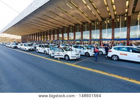 Rome, Italy - September 15, 2016: Taxi near the taxi stop and queue from people at  entrance of Termini Train Station in Rome