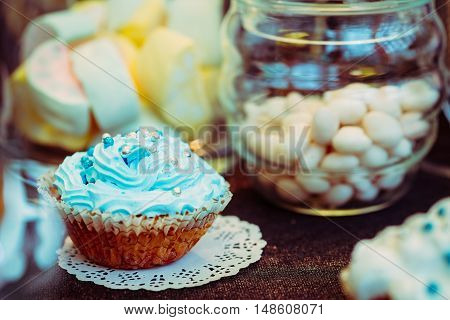 Dessert Sweet Tasty Cupcake In Candy Bar On Table. Delicious Sweet Buffet. Wedding Decorations. Faded Instant Film Effect