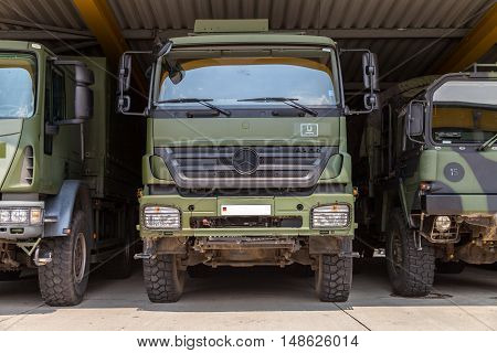 BURG / GERMANY - JUNE 25 : german military trucks stands under military roof on open day in barrack burg / germany at june 25 2016.