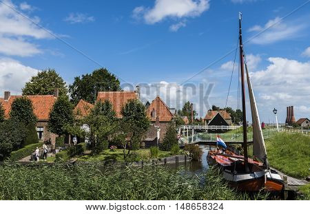 Enkhuizen The Netherlands - August 9 2016: Zuiderzee Museum Enkhuizen with old fisherman house fishing boat and small town in The Netherlands.