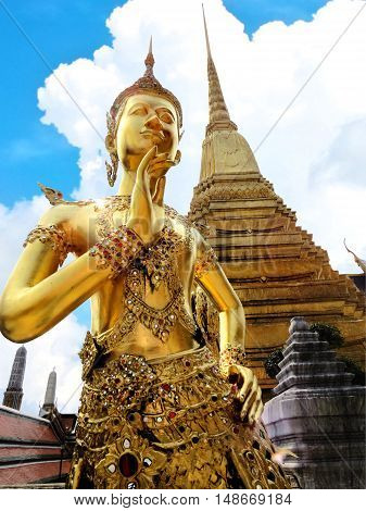 Golden Thep Kinnanorn statue at Temple of Emerald Buddha (Wat Phra Kaew) in Grand Royal Palace (The upper body as human and lower as bird) ,Bangkok,Thailand. Selective focus.