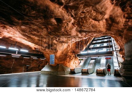 Stockholm, Sweden - July 30, 2014: Radhuset, The Modern Metro Underground Subway Station With Unusual Brown Ceiling Looking Like Cave Vault And Moving Staircases.