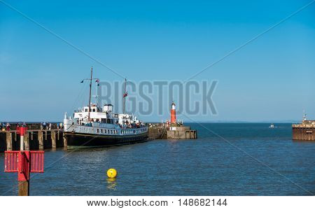 Watchet United Kingdom - August 15 2016: Passengers are walking to board the MV Balmoral ship to continue their Bristol Channel cruise after a one hour stop in Watchet harbour.