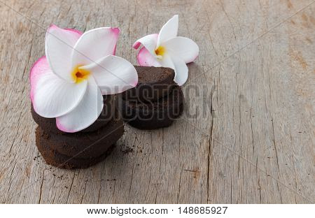 Closeup Plumeria sweet color and coffee ground on old wood background skin care beauty and spa relax concept