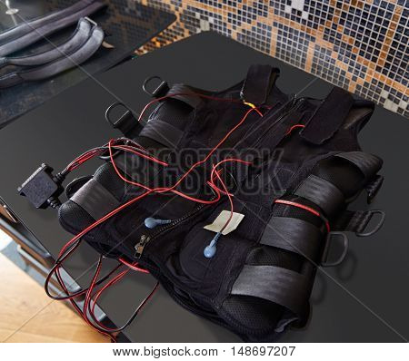 EMS electro stimulation suit detail on a black board