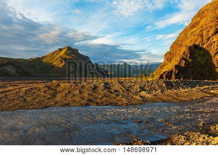 Midnight setting sun lits beautifully volcanic rocks at Thorsmork, Iceland