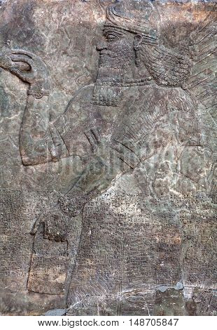 Standing Genie - ancient relief slab from a wall from the palace of King Assurnasirhpal II (883-889 B.C.) from Kalhu (Nimrud)