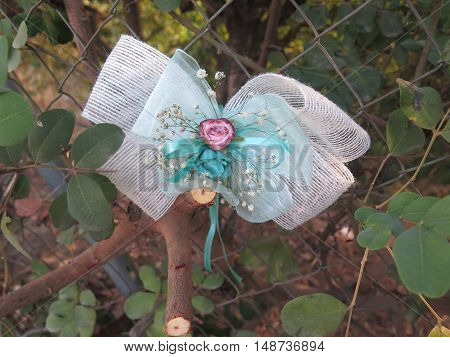 Wedding bow and Rose on fence in layby