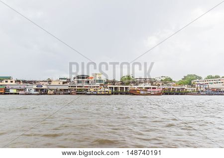 Bangkok Thailand - June 5 2016: Right hand side of Chao Phraya River on cloudy day. It is at the same side of Siriraj Hospital part of Mahidol university.