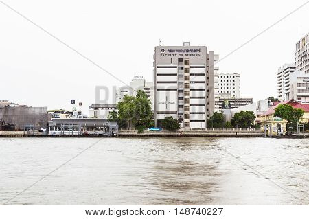 Bangkok Thailand - June 5 2016: The faculty of Nursing Mahidol university view from the other side of Chao Phraya River on cloudy day