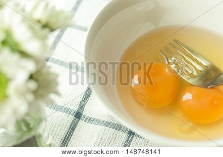 egg prepare for cooking, on the tablecloth and mum flower