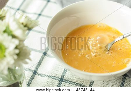 egg prepare for cooking, on the tablecloth and mum flower