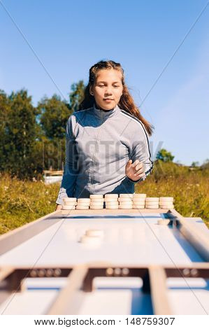 teenager girl playing the Board game on the street