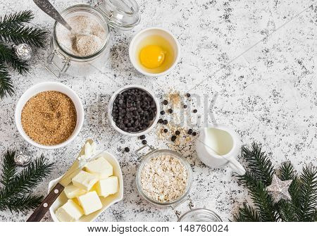 Christmas baking background. Flour sugar butter rolled oats eggs chocolate chips on a light background. Baking ingredients