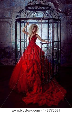 Fashion photo of young magnificent woman in red dress.