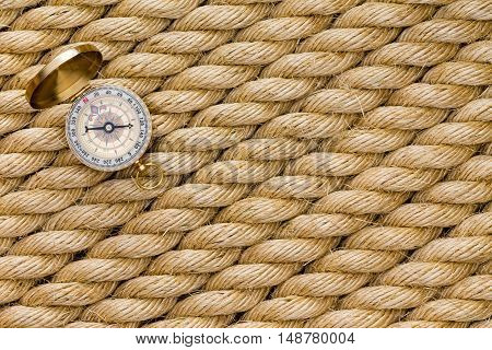 Small Magnetic Compass On Diagonal Strands Of Rope