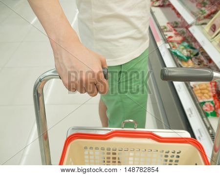 A man is shopping in the supermarket