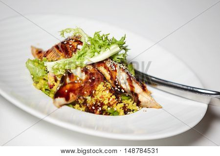 Breast of Duck Salad with Sauce on white plate