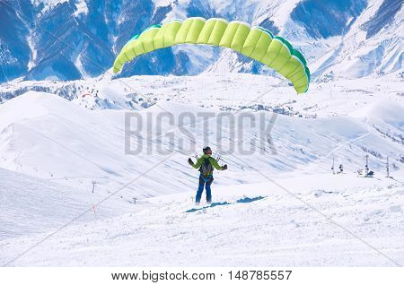 Fly in mountains by paraglider. Free happy life in mountains. Travel extreme concept.