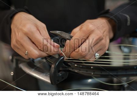 Close Up Of Tennis Stringer Hands Doing Racket Stringing