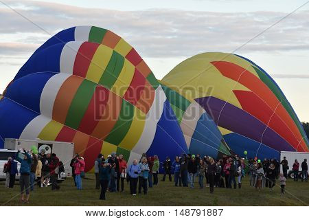QUEENSBURY, NY - SEP 24: Balloon launch at dawn at the 2016 Adirondack Hot Air Balloon Festival held from Sep 22-25. Thousands of people attended the festival which is the largest of its kind on the East coast.