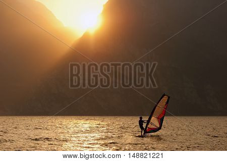 Young man surfing the wind during sunset