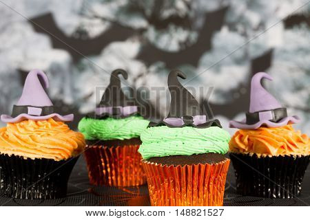 Delicious cupcakes decorated with fondant figures for Halloween
