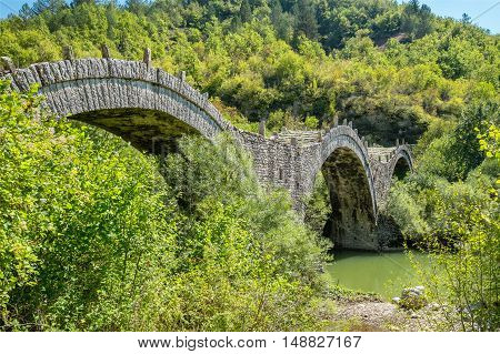 Three arches stone bridge of Kalogeriko (or Plakida) on the river of Voidomatis near the villages of Kipi and Koukouli in the Central Zagori. Greece