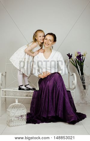 young mother with daughter at luxury home interior vintage, old fashion relashionship family