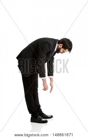 Young businessman bending down.