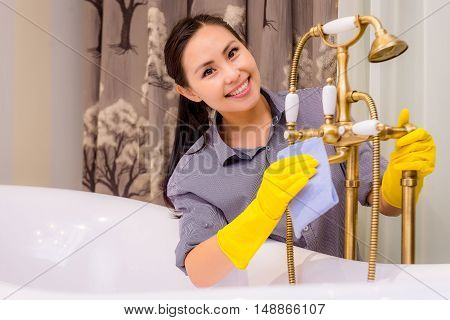Young beautiful asian woman housekeeping in the bathroom