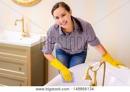 Young beautiful asian woman housekeeping in the bathroom