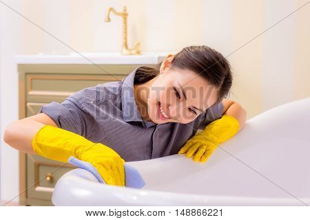Young beautiful asian woman housekeeping in the bathroom