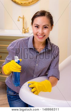 Young beautiful asian woman housekeeping in the bathroom